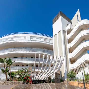 a building with a white wall and balconies
