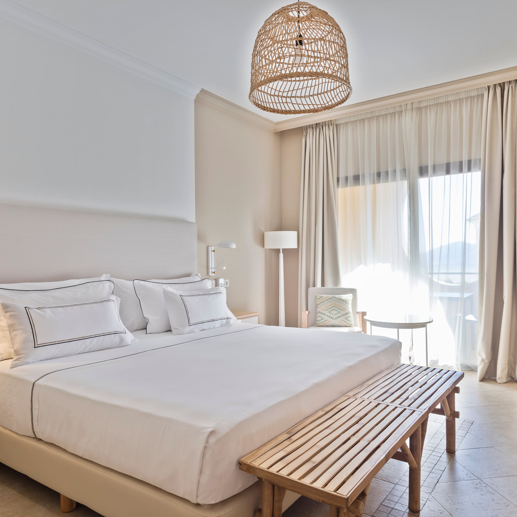 a bed with a bench and a lamp