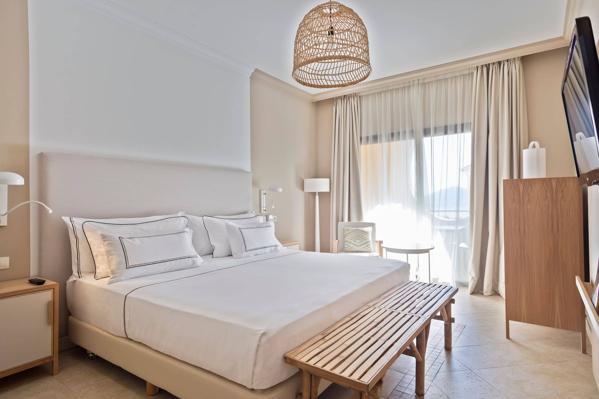 a bed with a bench and a lamp