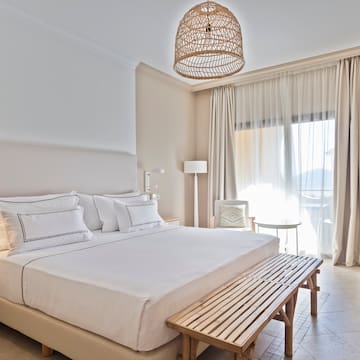 a bed with a bench and a lamp