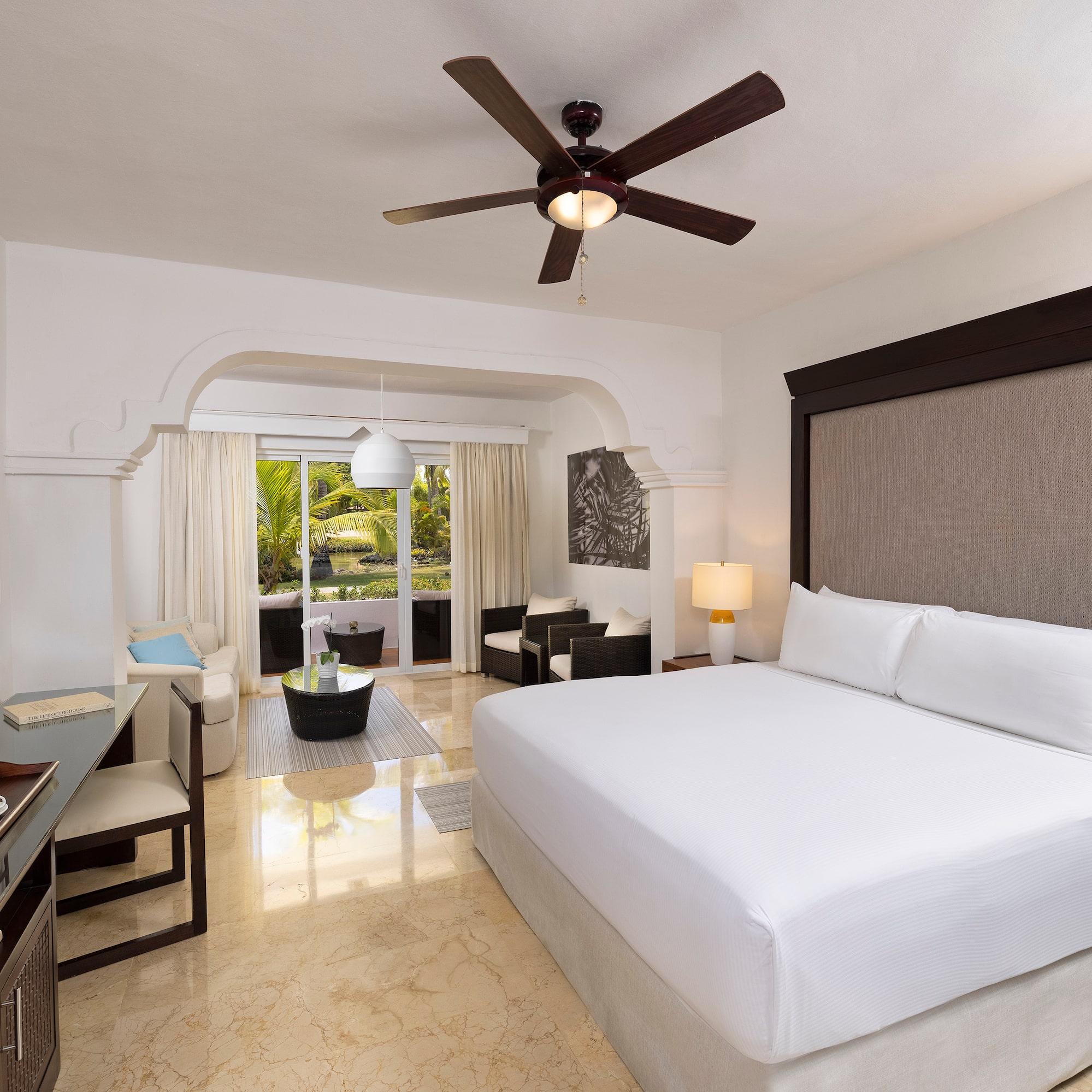 a room with a bed and a ceiling fan