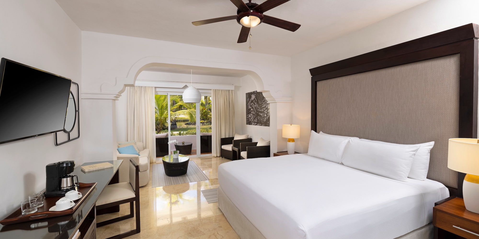 a room with a bed and a ceiling fan
