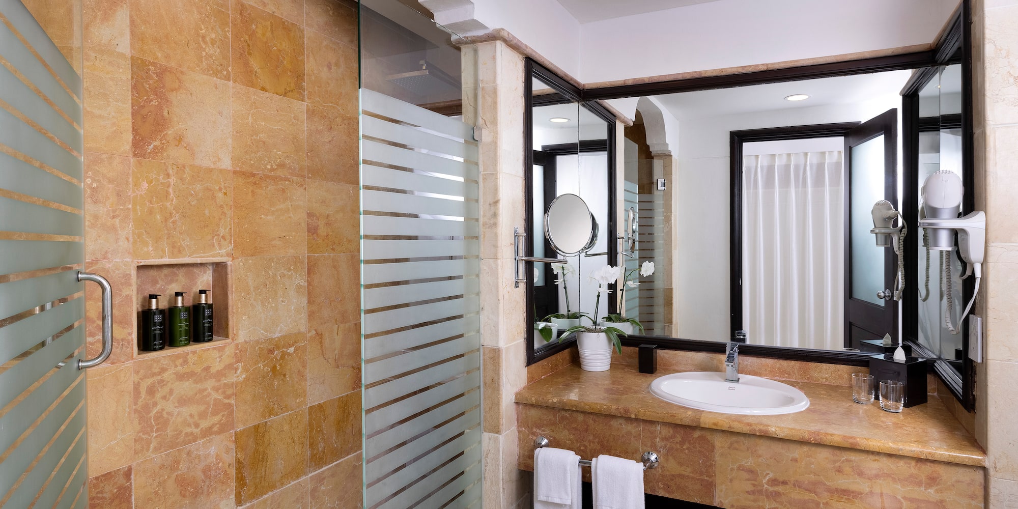 a bathroom with a shower and sink