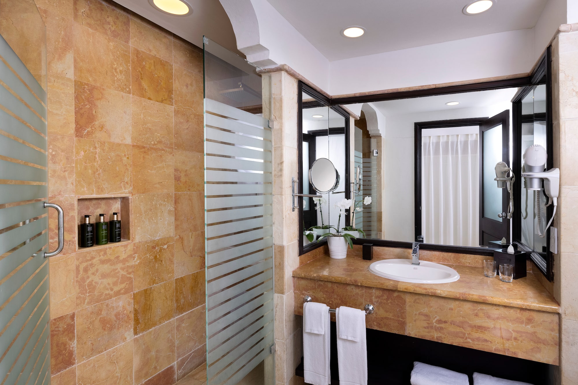 a bathroom with a shower and sink