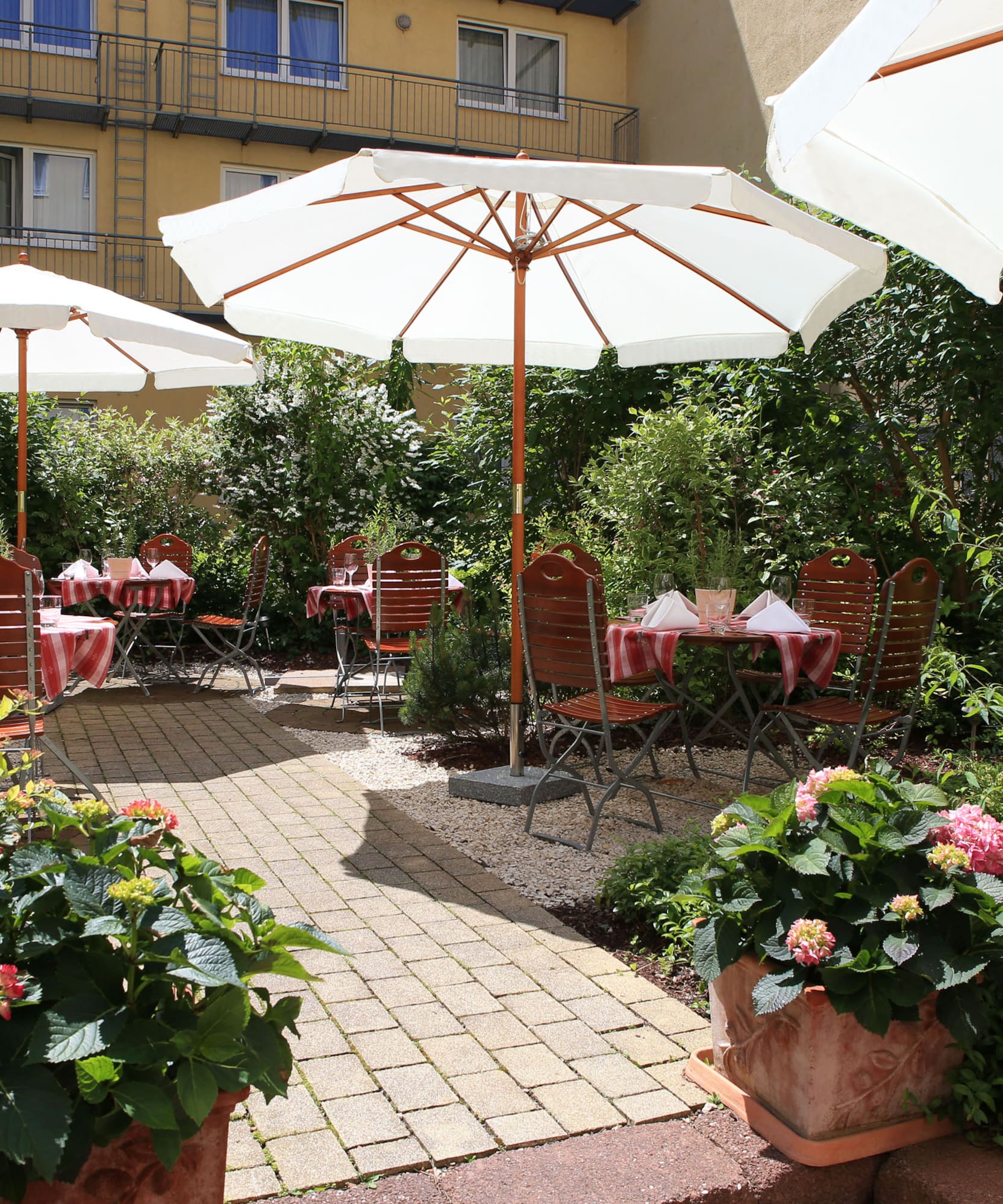a patio area with chairs and umbrellas