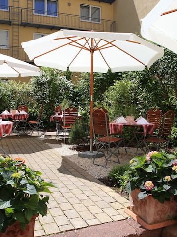 a patio area with chairs and umbrellas