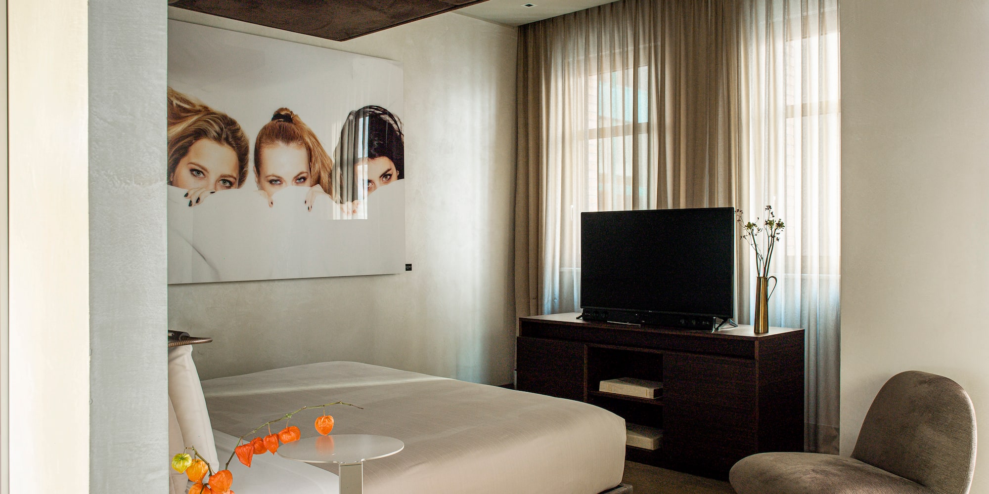 a bedroom with a bed and a tv