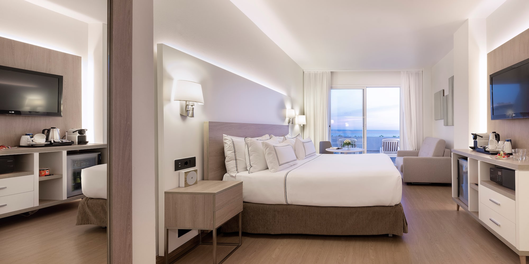 a bedroom with a large bed and a mirror