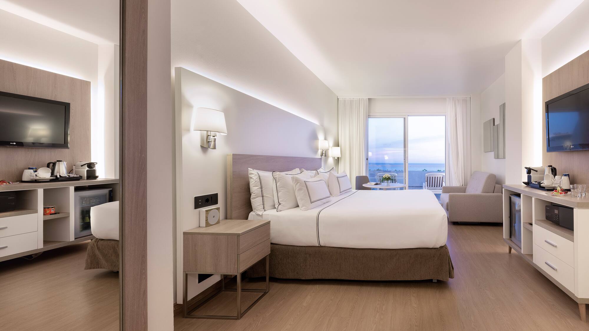 a bedroom with a large bed and a mirror