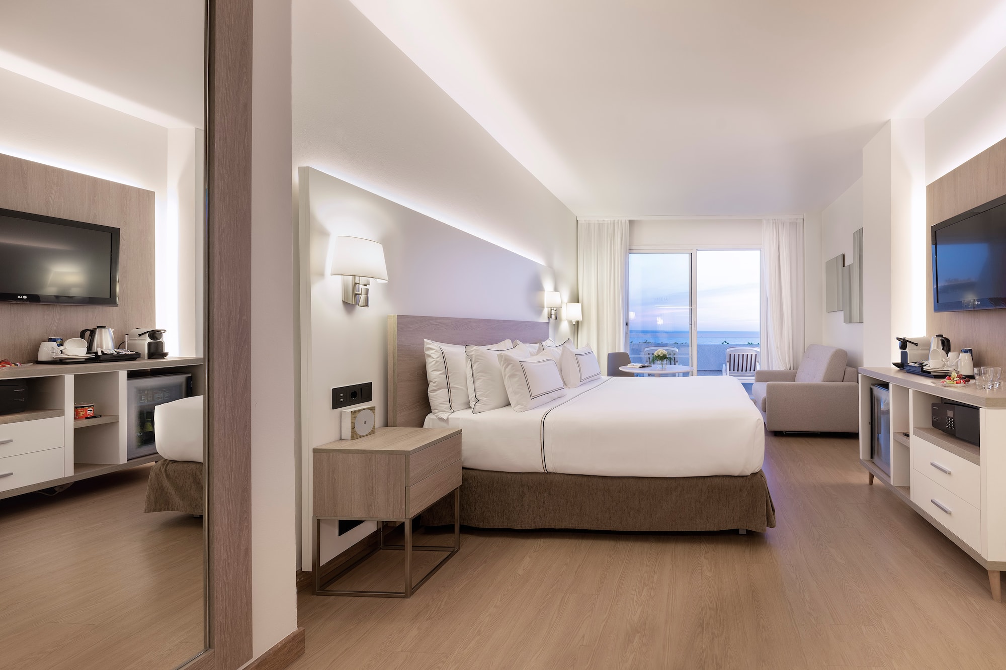 a bedroom with a large bed and a mirror