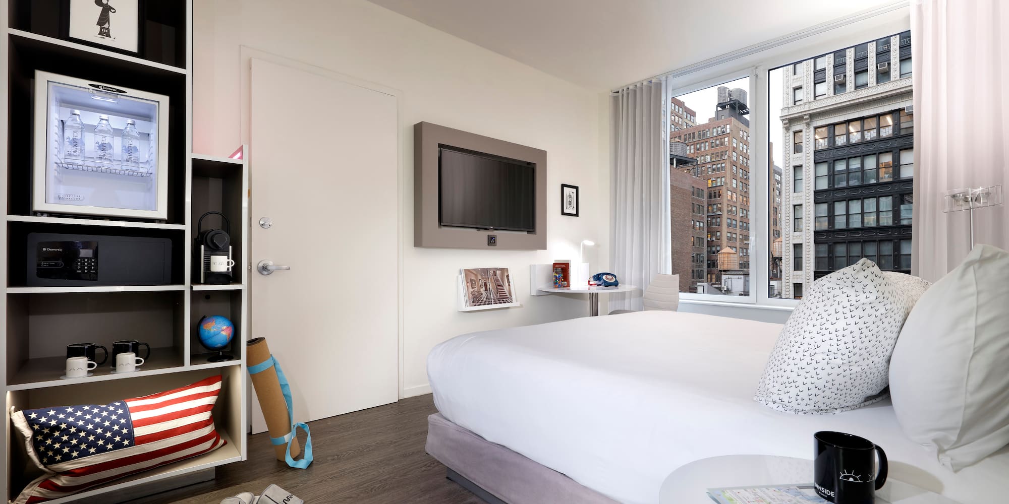 a bedroom with a large window and a bed