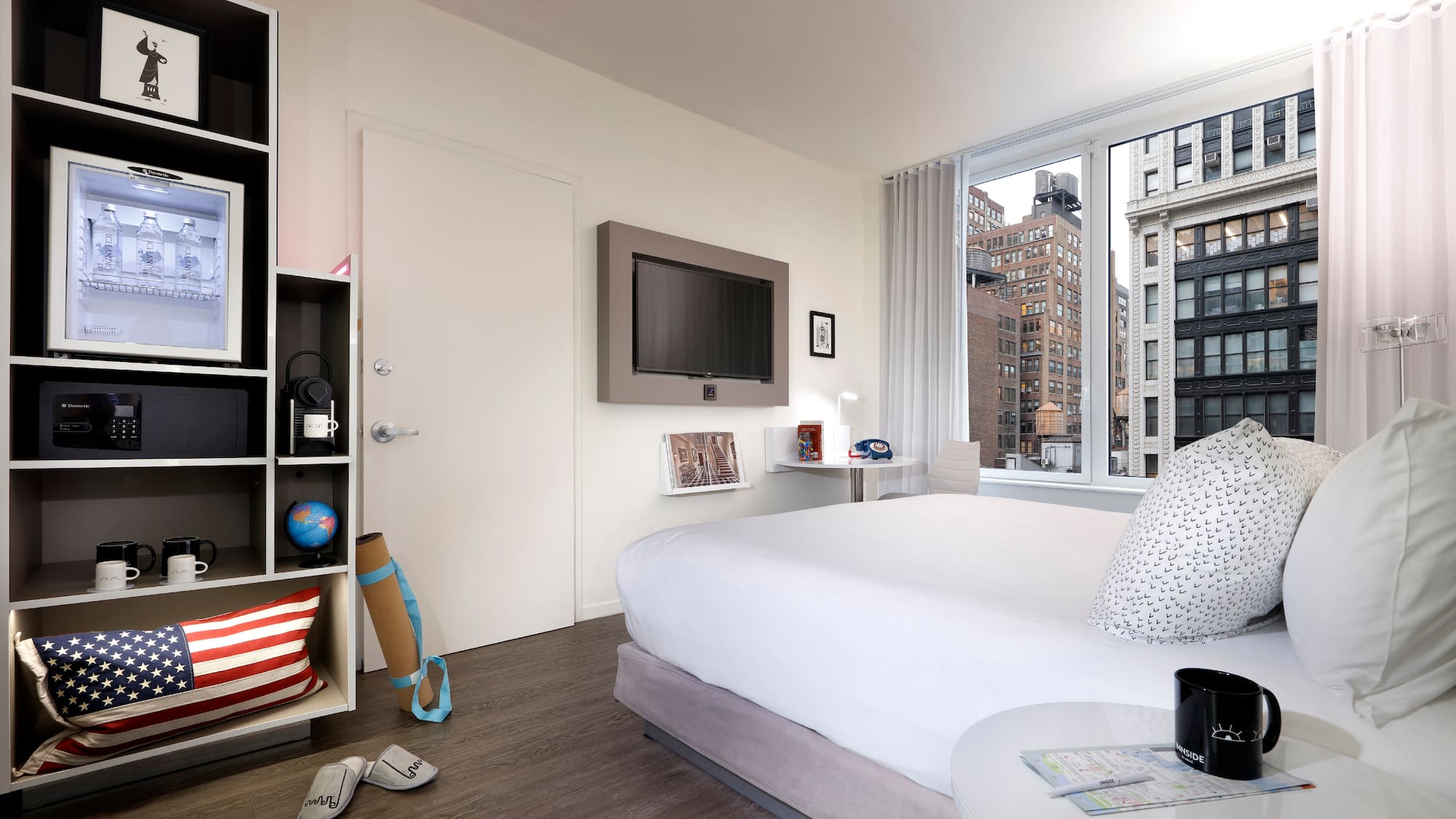 a bedroom with a large window and a bed