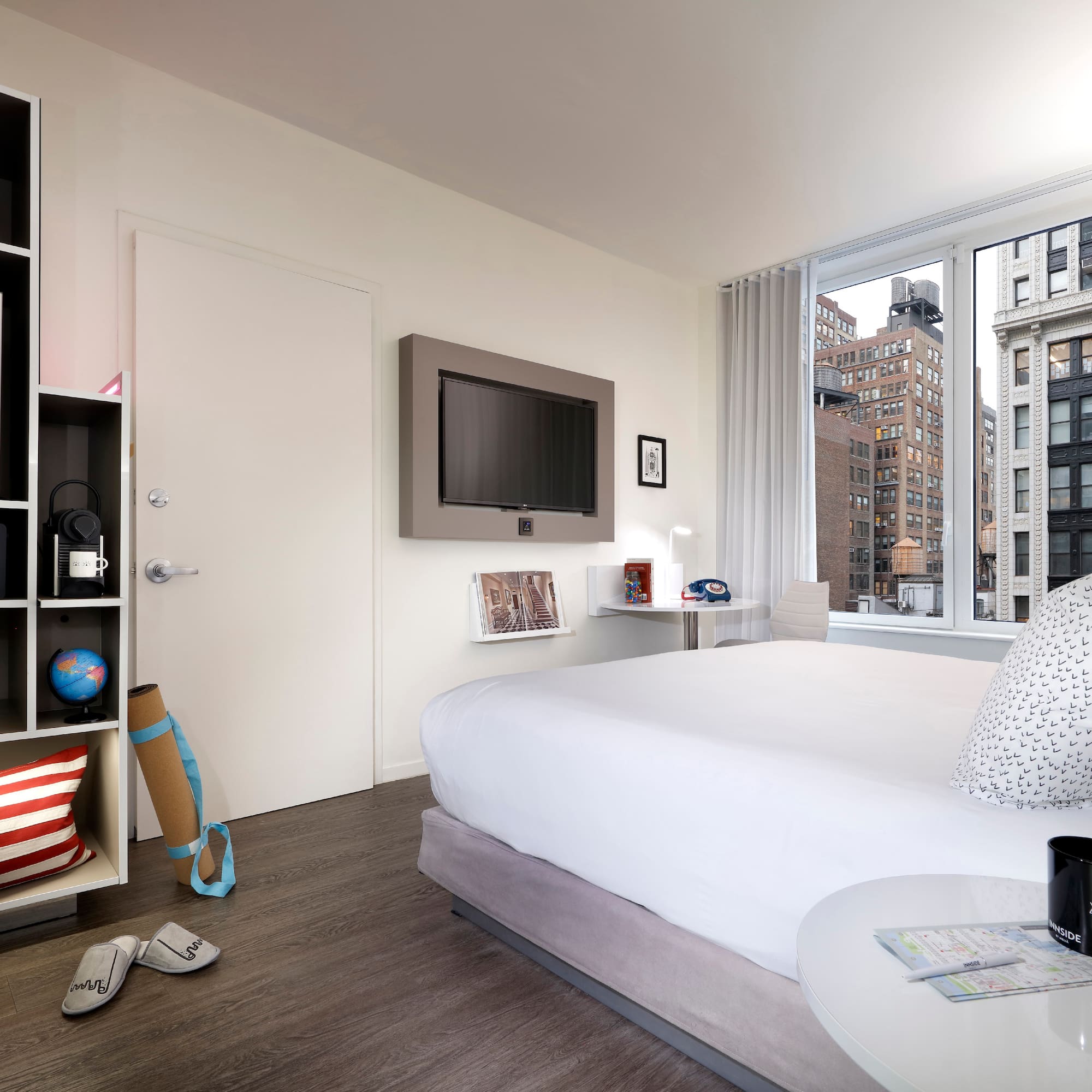 a bedroom with a large window and a bed