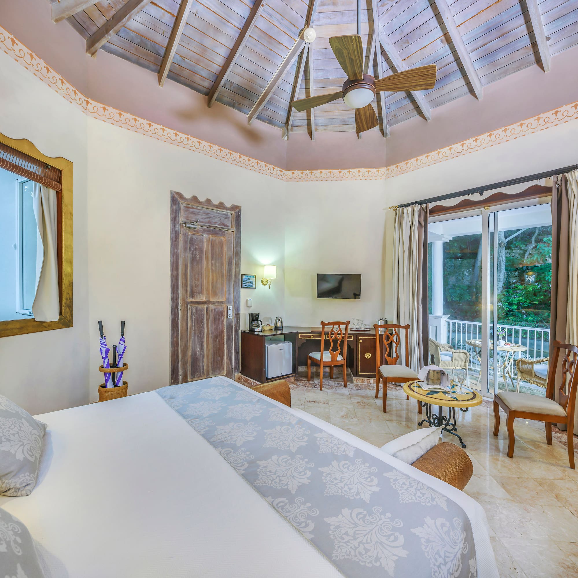 a room with a ceiling fan and a bed