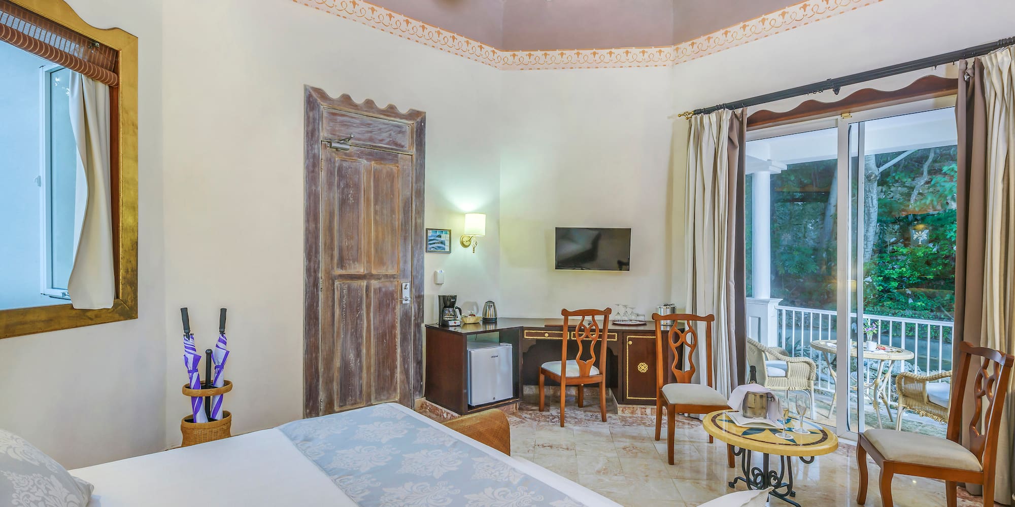 a room with a ceiling fan and a bed