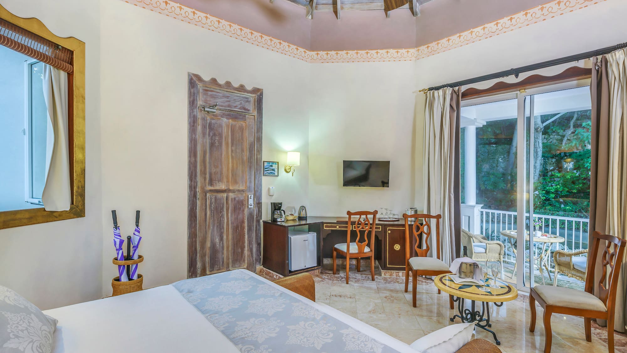 a room with a ceiling fan and a bed