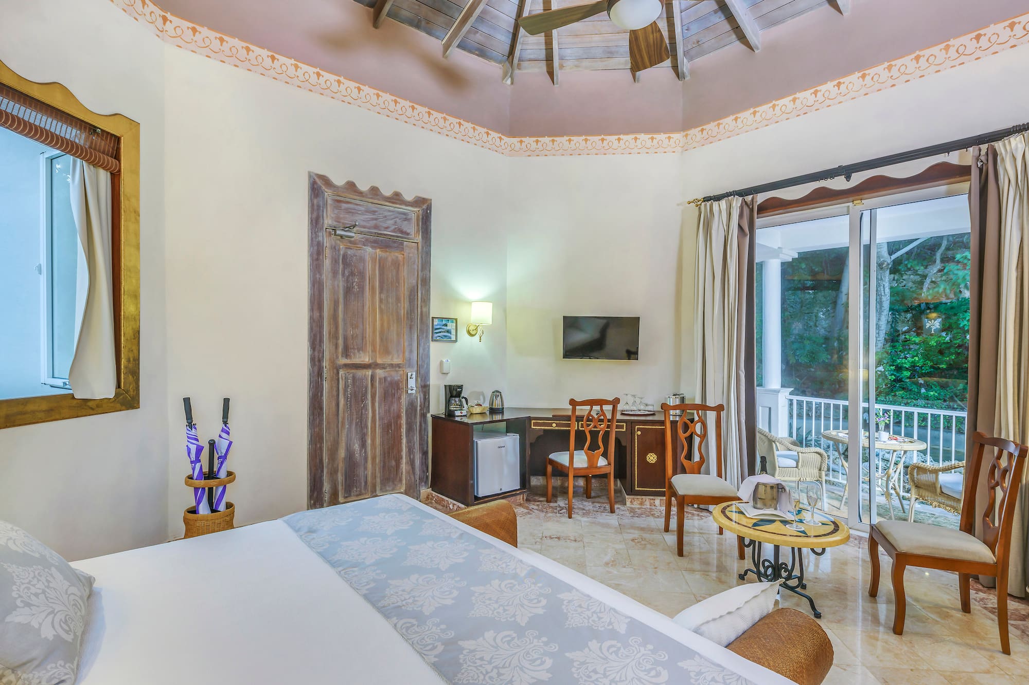 a room with a ceiling fan and a bed