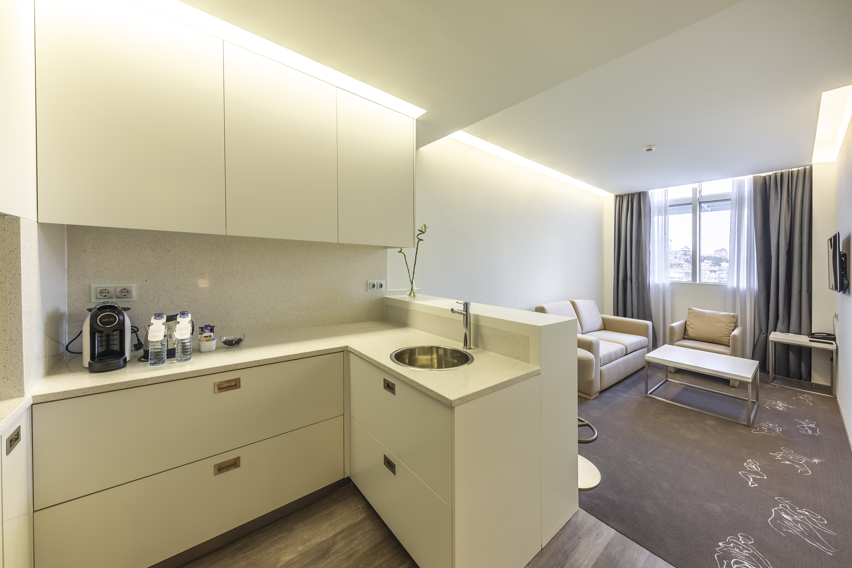Modern studio apartment with sleek kitchenette and inviting living area.