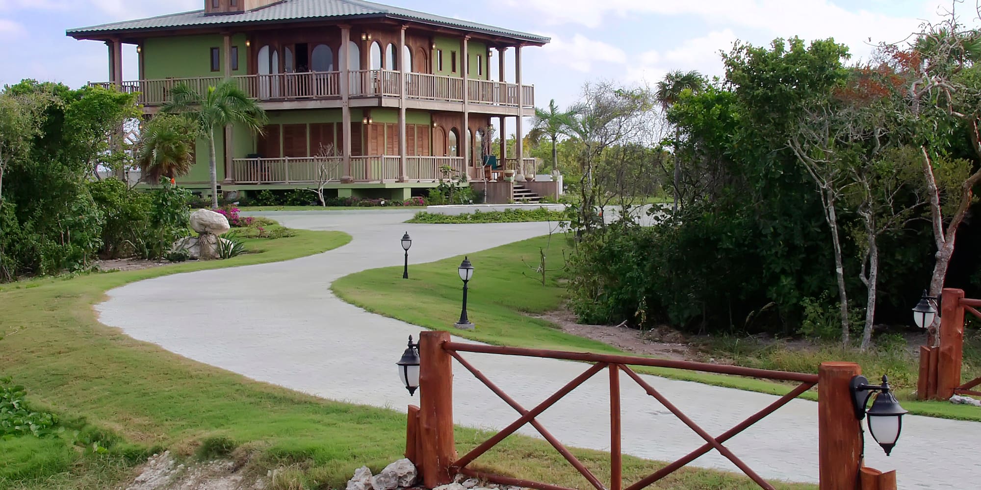a house with a walkway and a fence