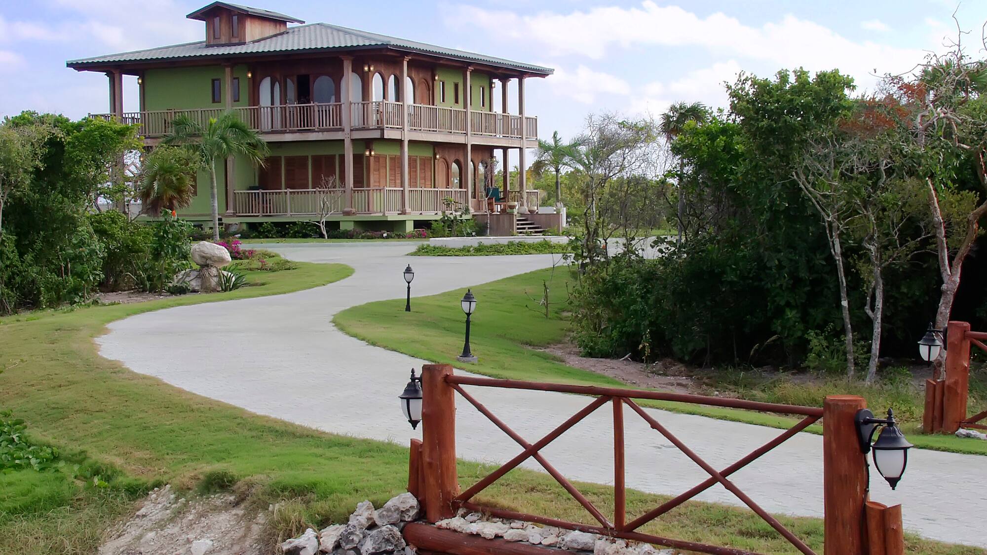 a house with a walkway and a fence