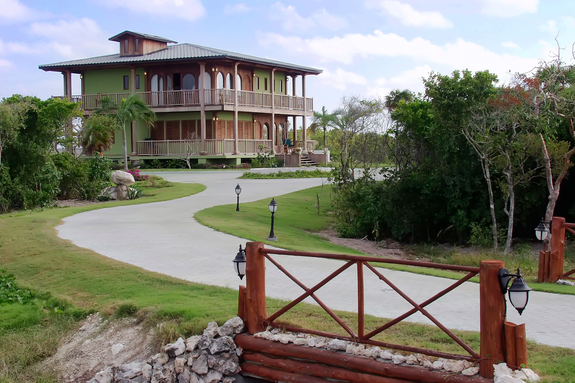 a house with a walkway and a fence