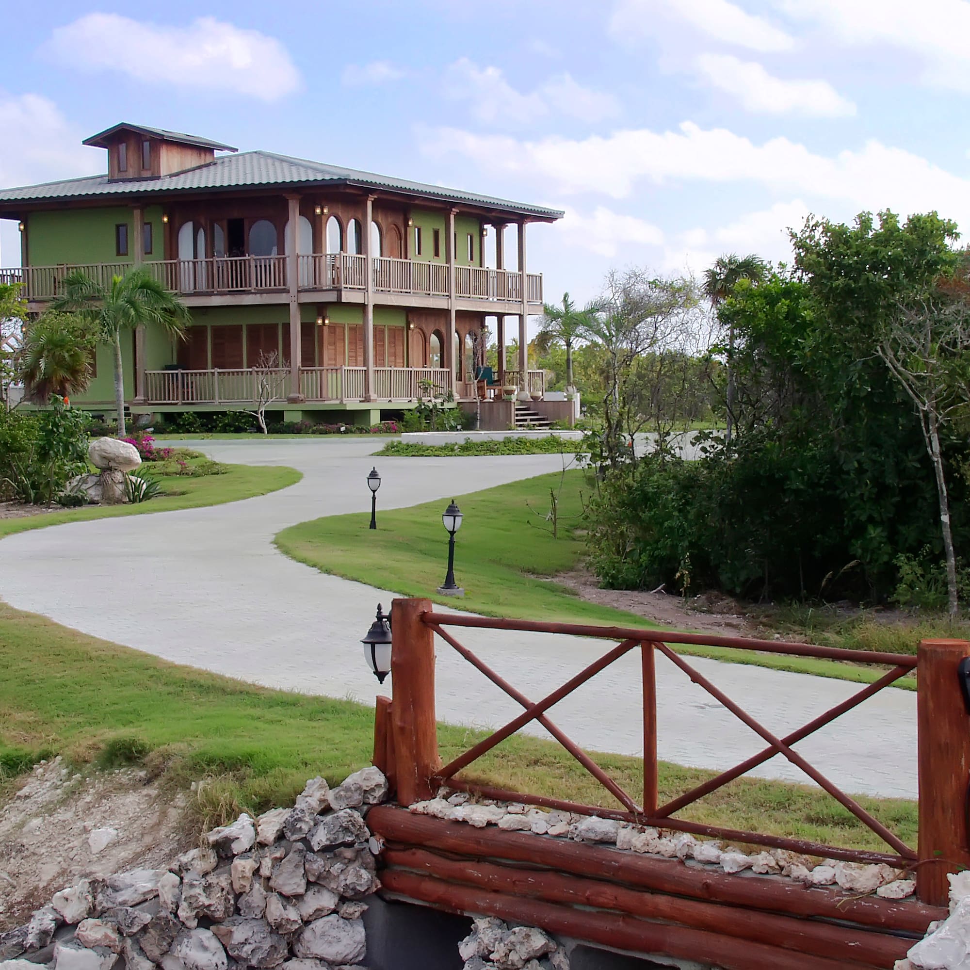 a house with a walkway and a fence