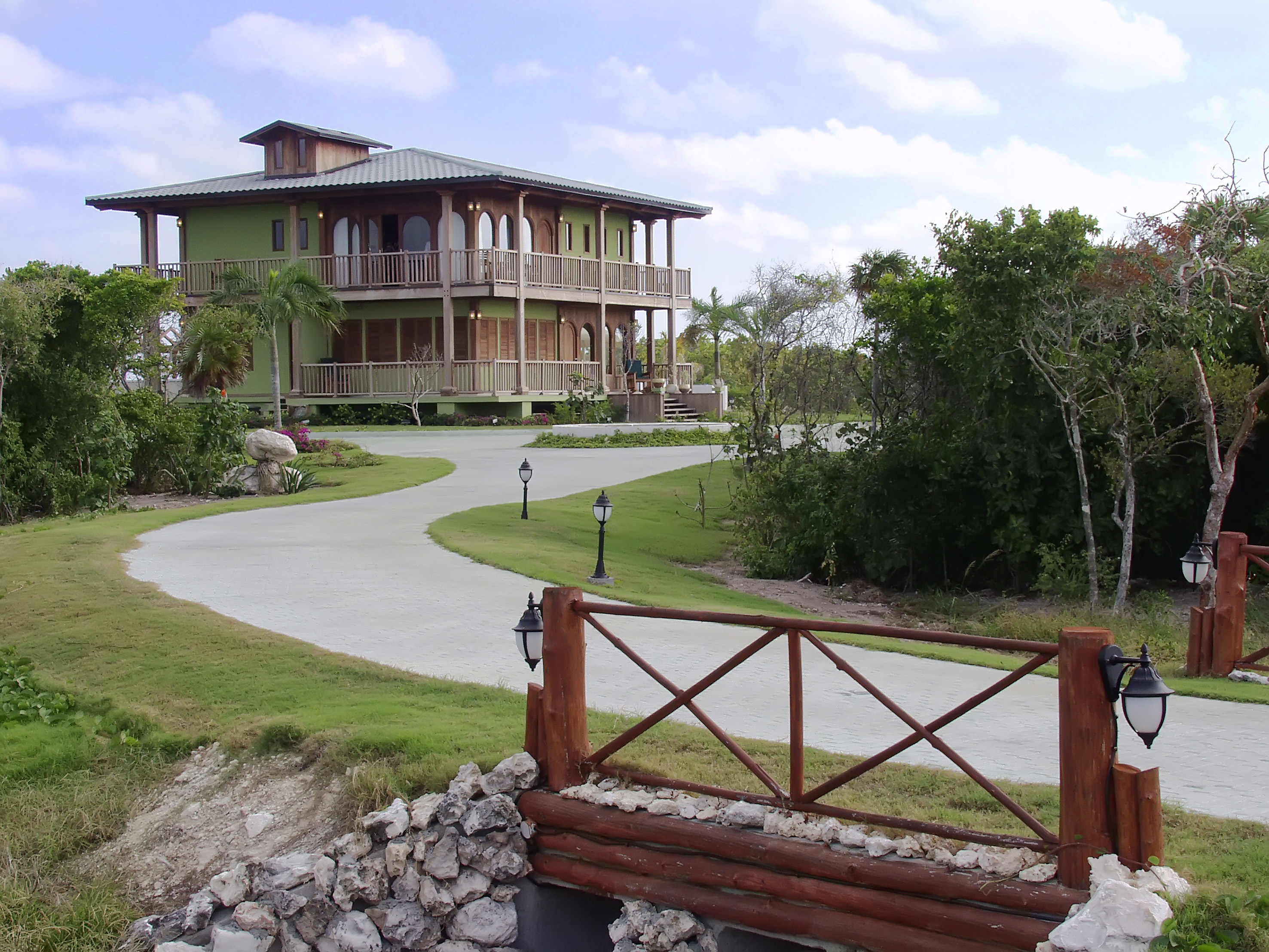 a house with a walkway and a fence
