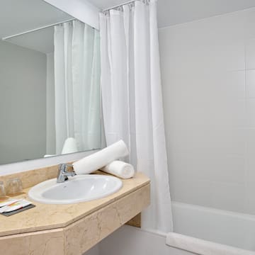 a bathroom with a sink and a shower curtain