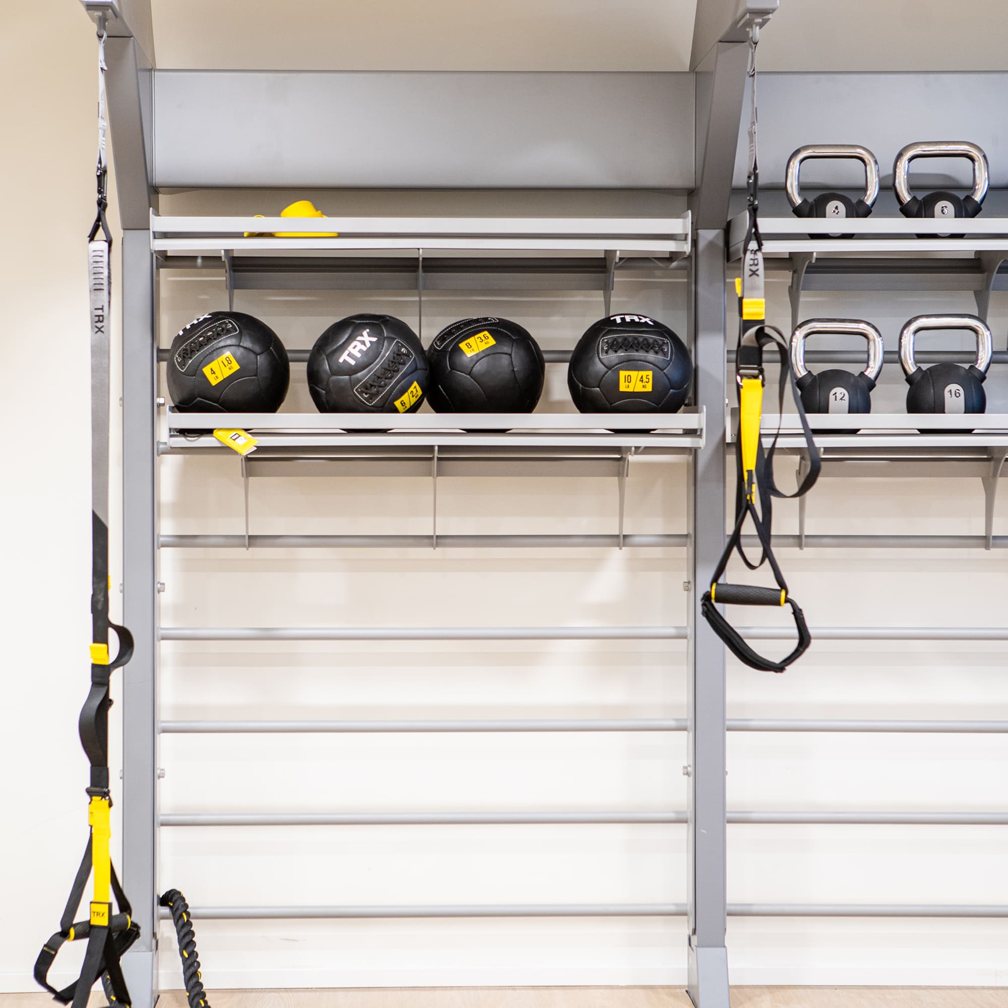 a wall with a rack with weights and balls