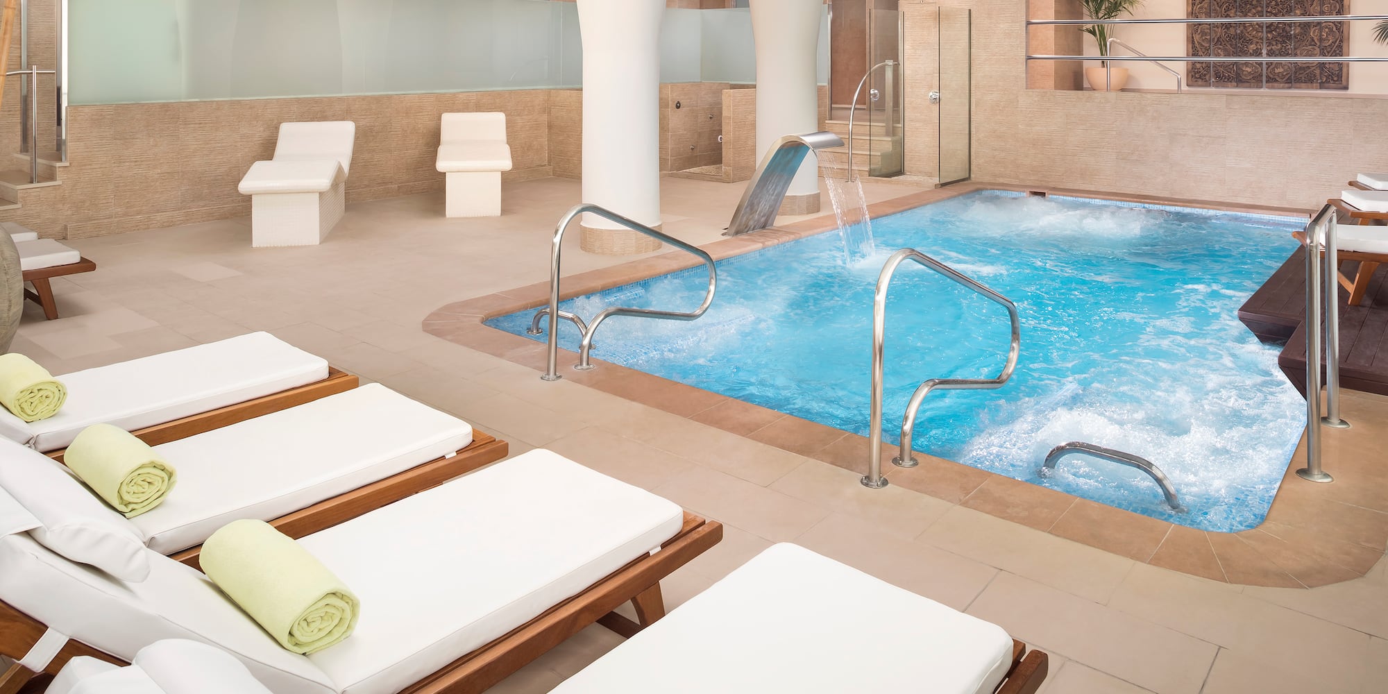 a pool with a water slide and chairs