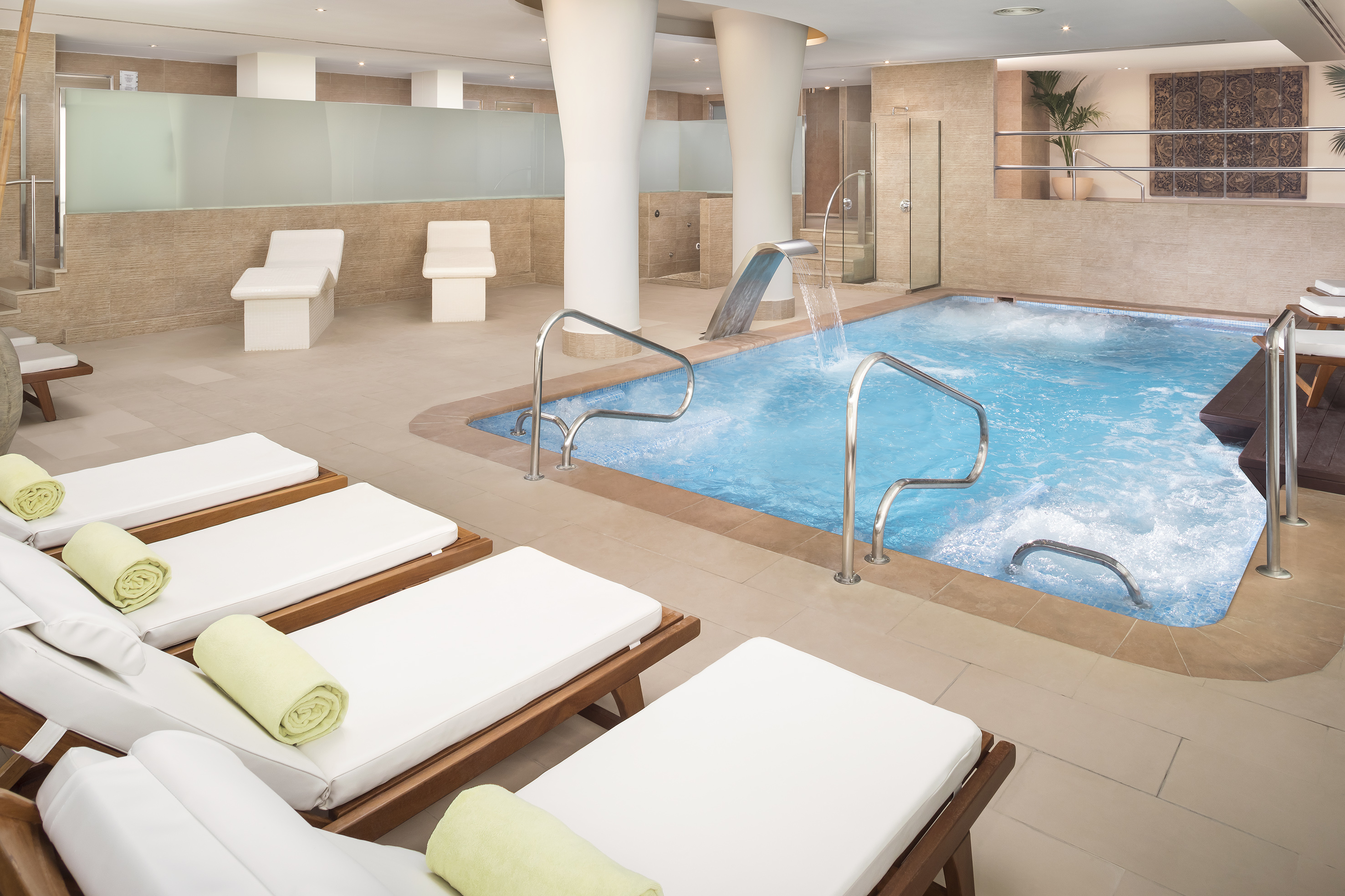 a pool with a water slide and chairs