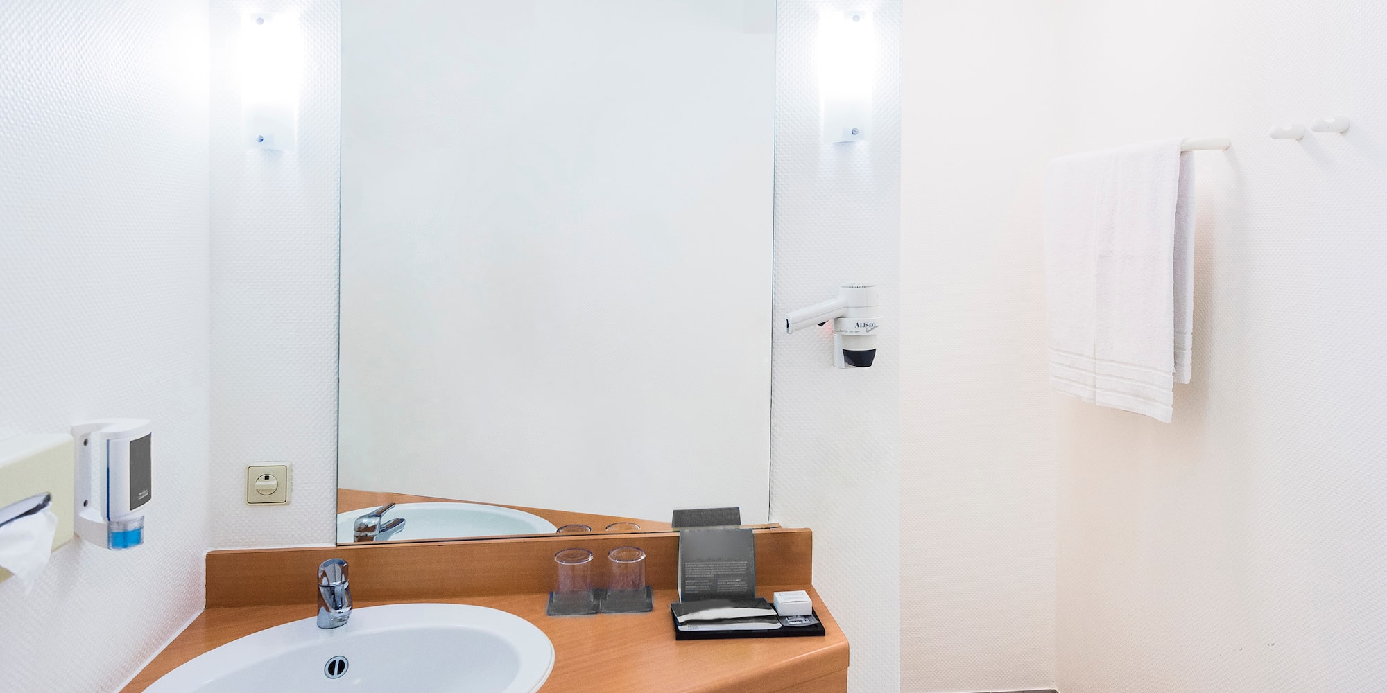 a bathroom with a mirror and sink