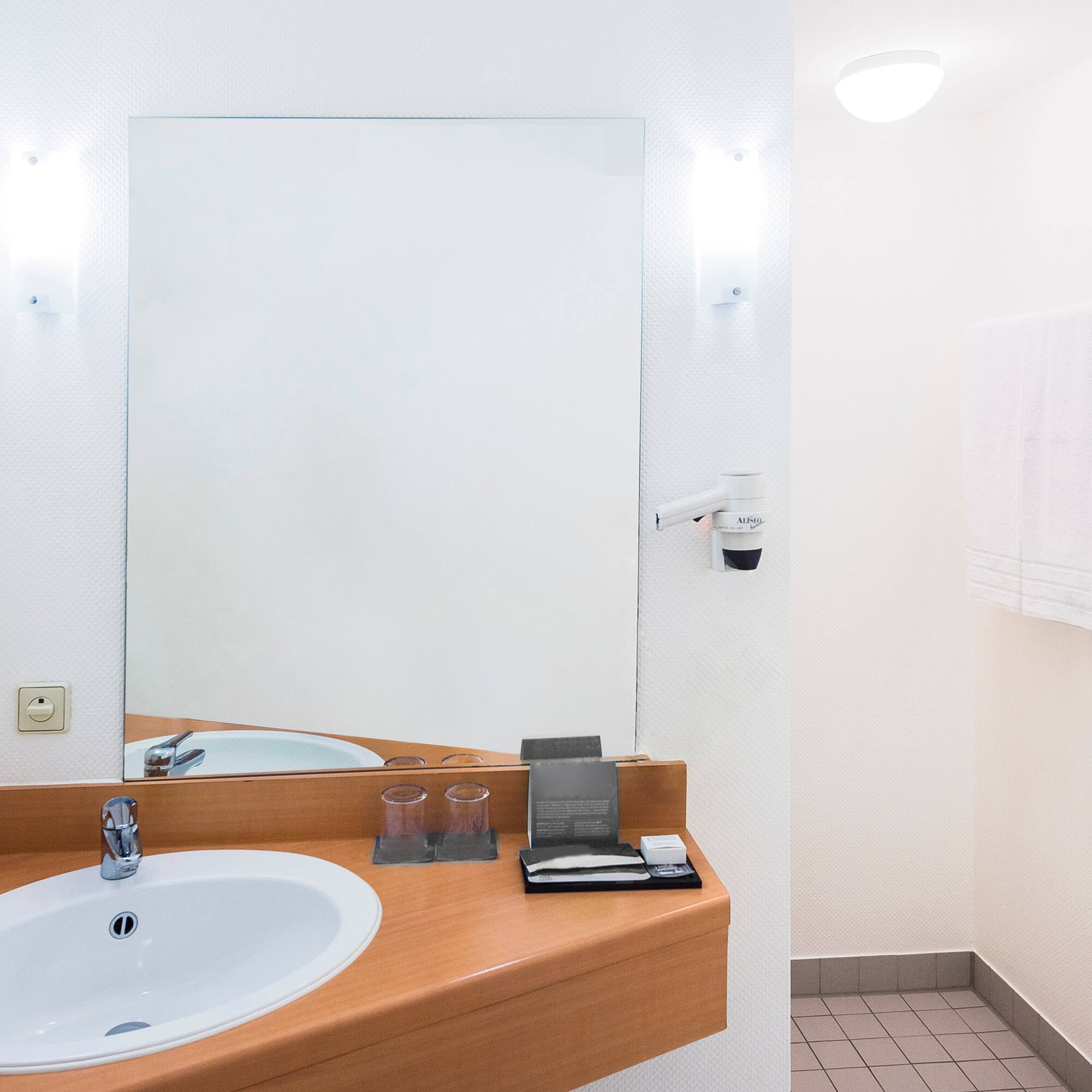 a bathroom with a mirror and sink