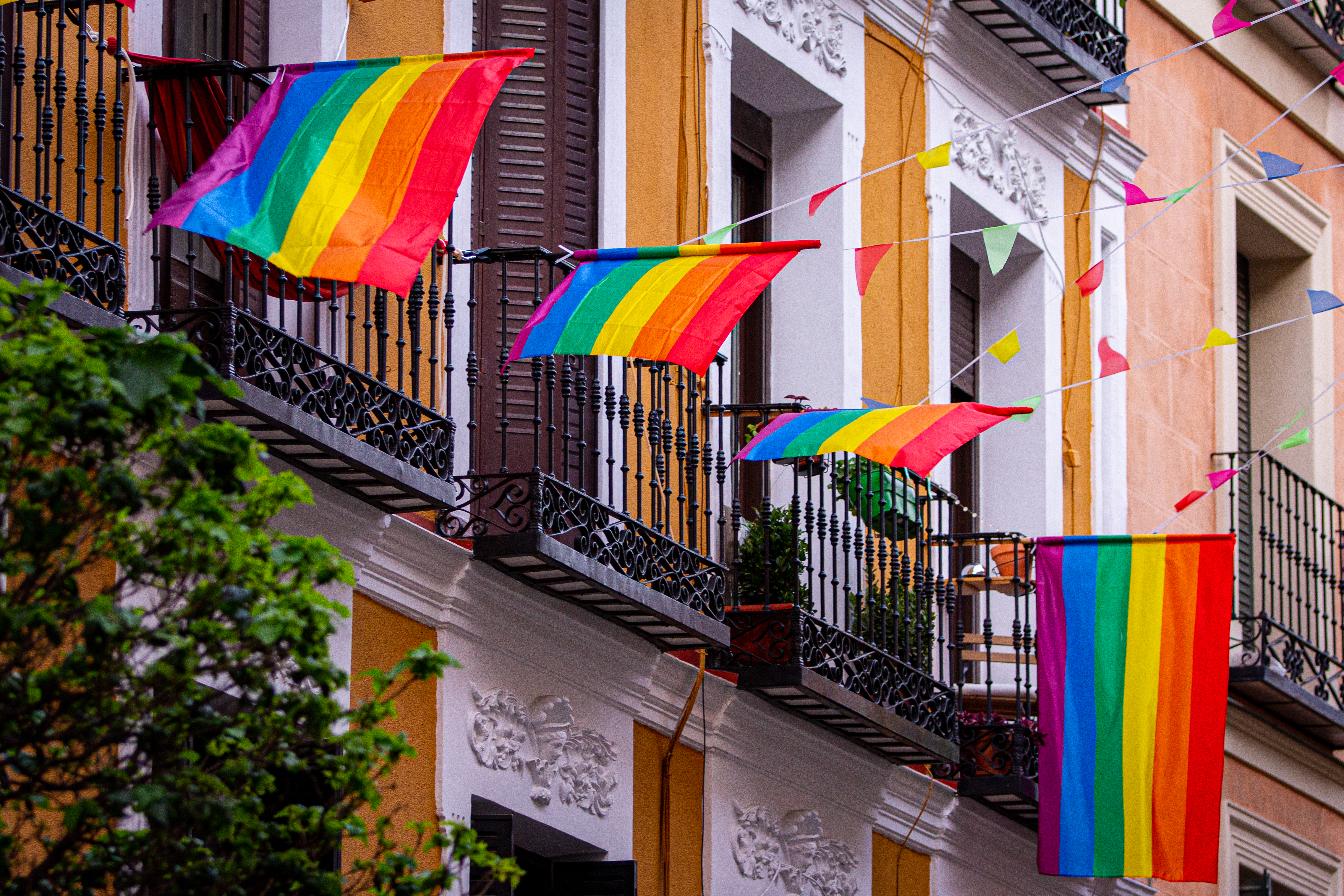 a rainbow flag on a balcony