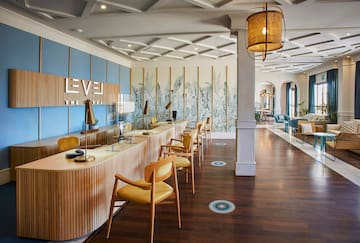 a room with a long counter and chairs