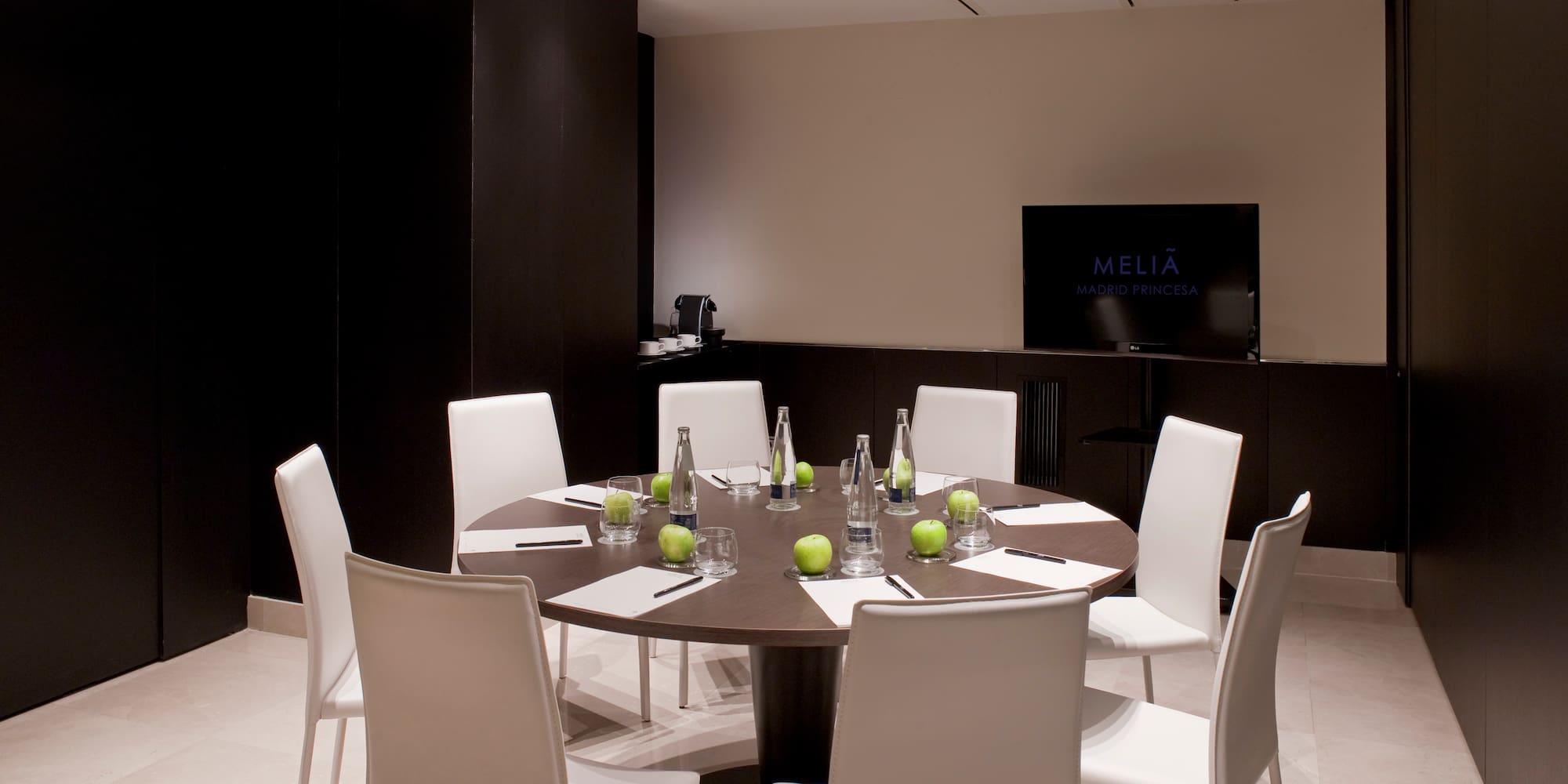 a room with a round table and chairs