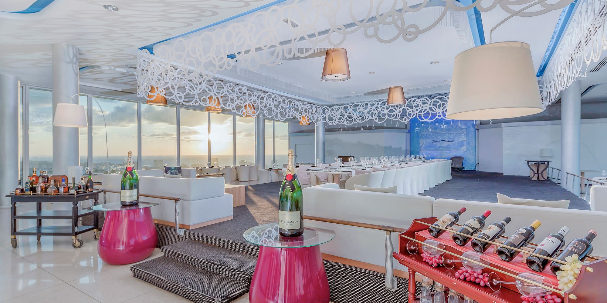 a room with a table and chairs and wine bottles