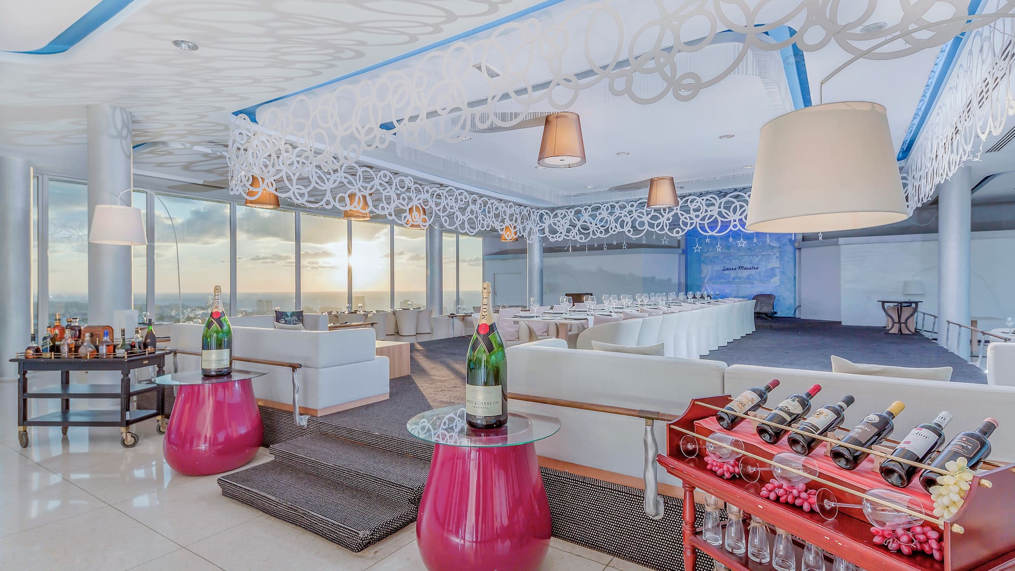 a room with a table and chairs and wine bottles