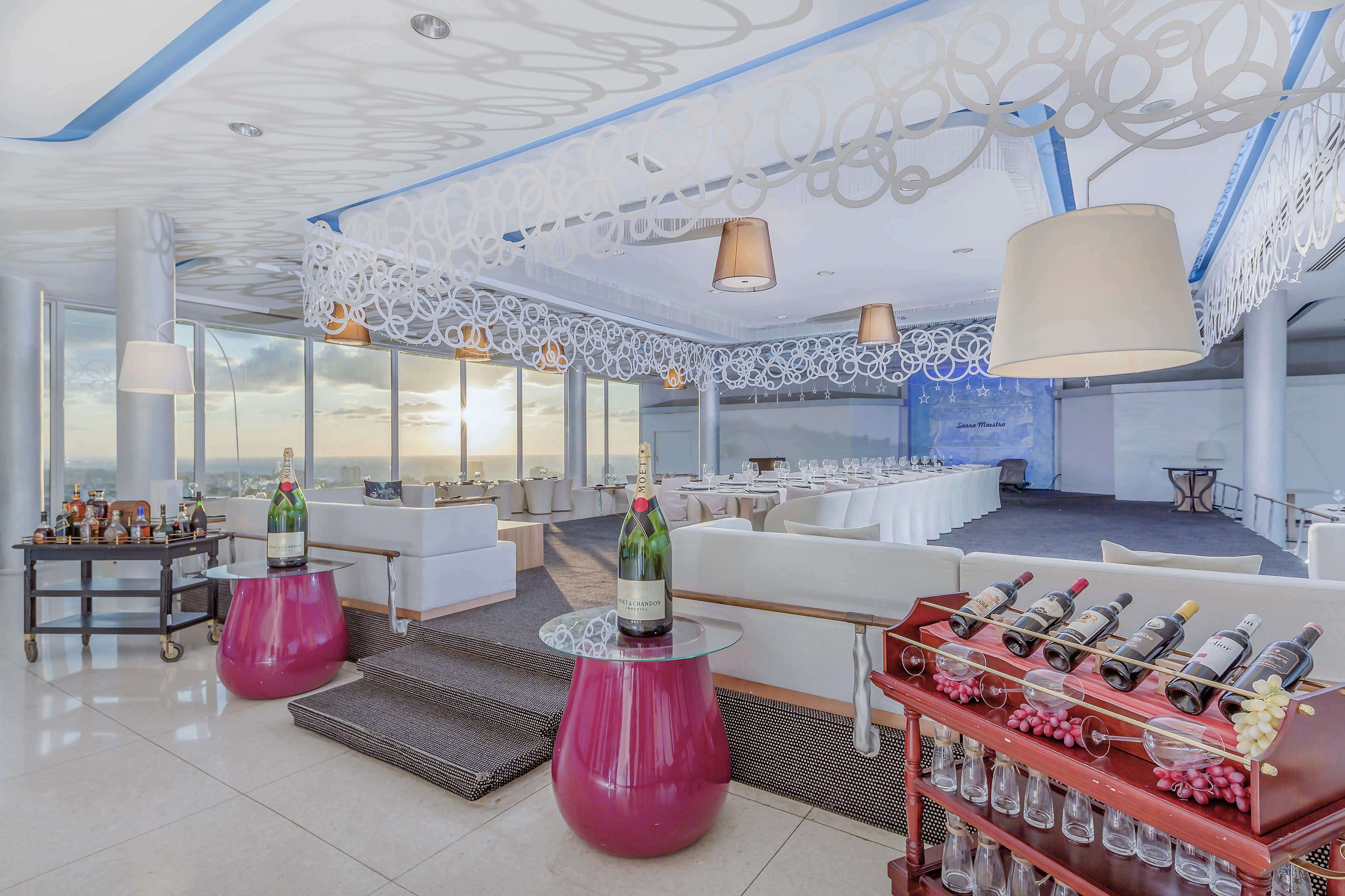 a room with a table and chairs and wine bottles