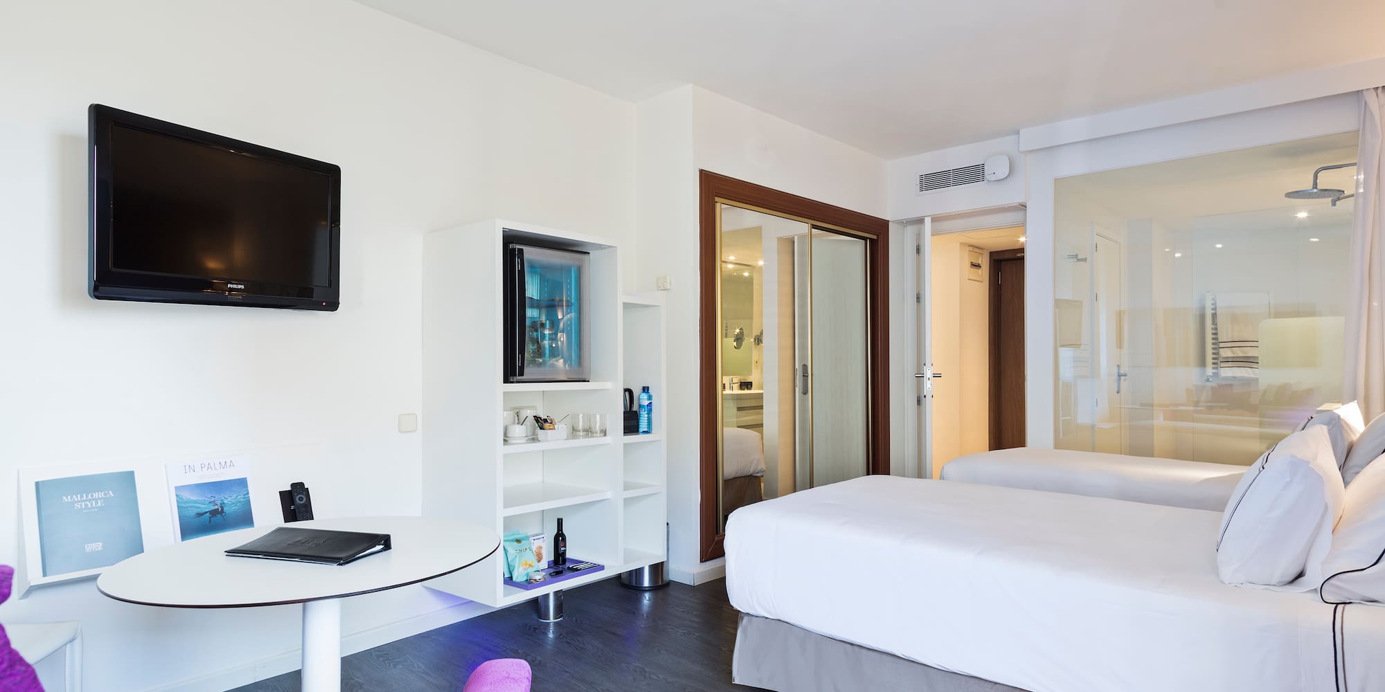 a room with two beds and a television