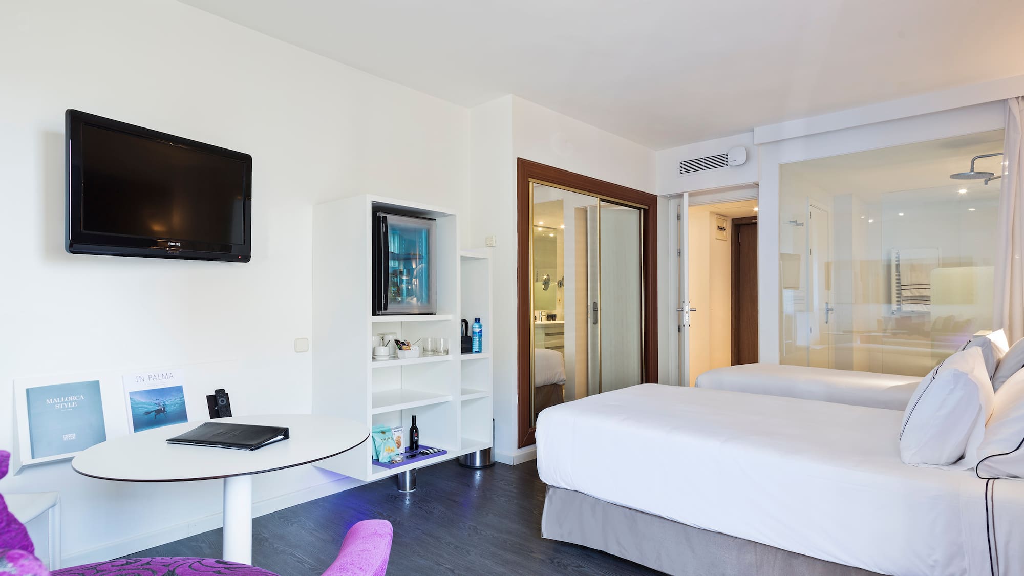 a room with two beds and a television