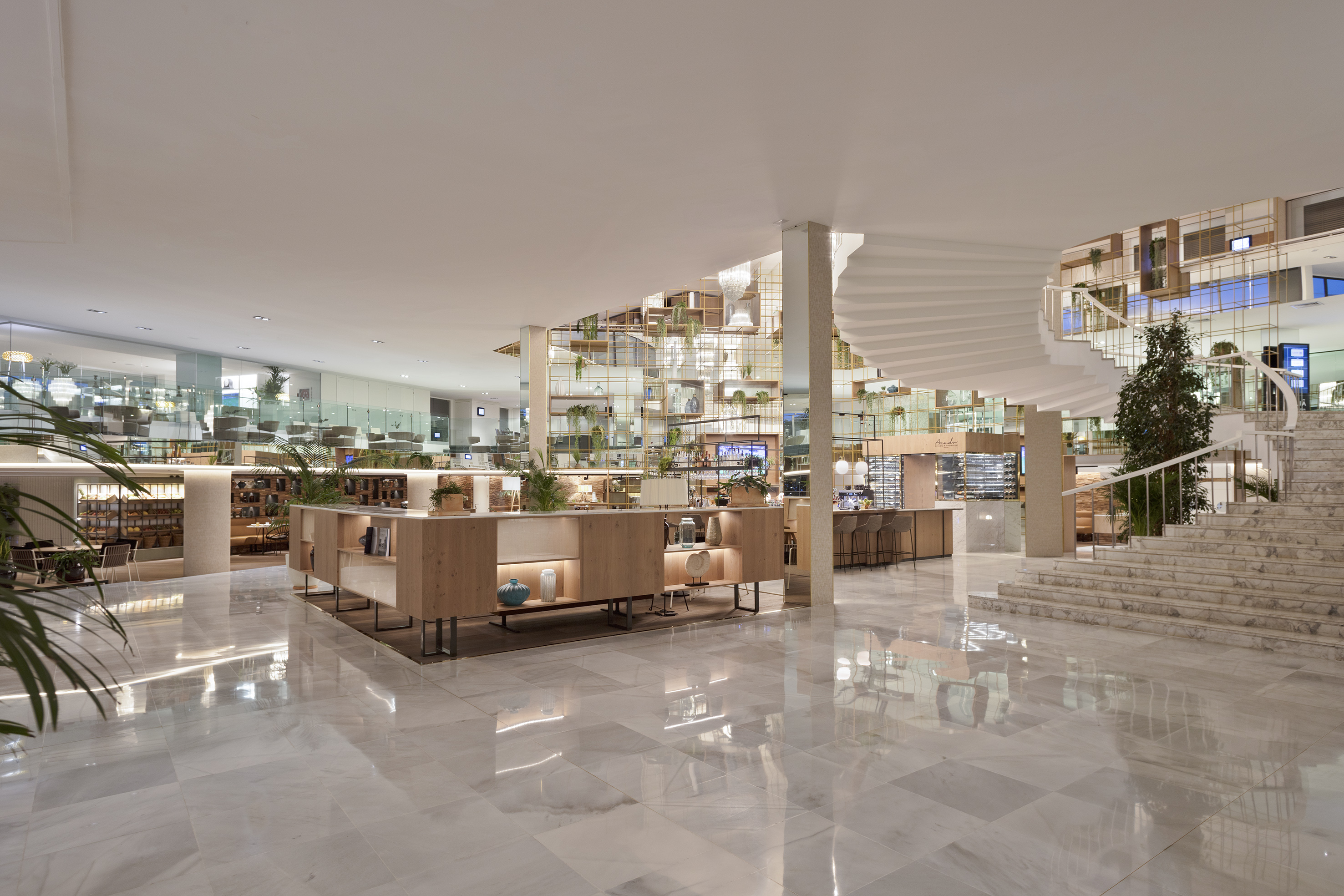 Modern hotel lobby with marble floor, white spiral staircase, and bar.