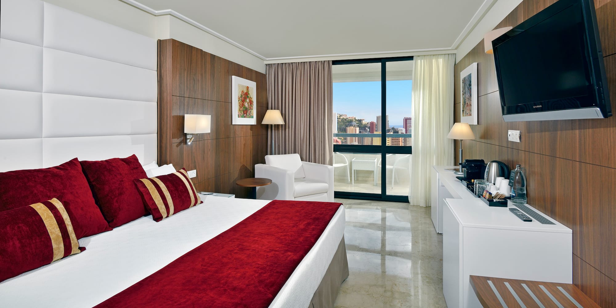 a bedroom with a bed and a white chair