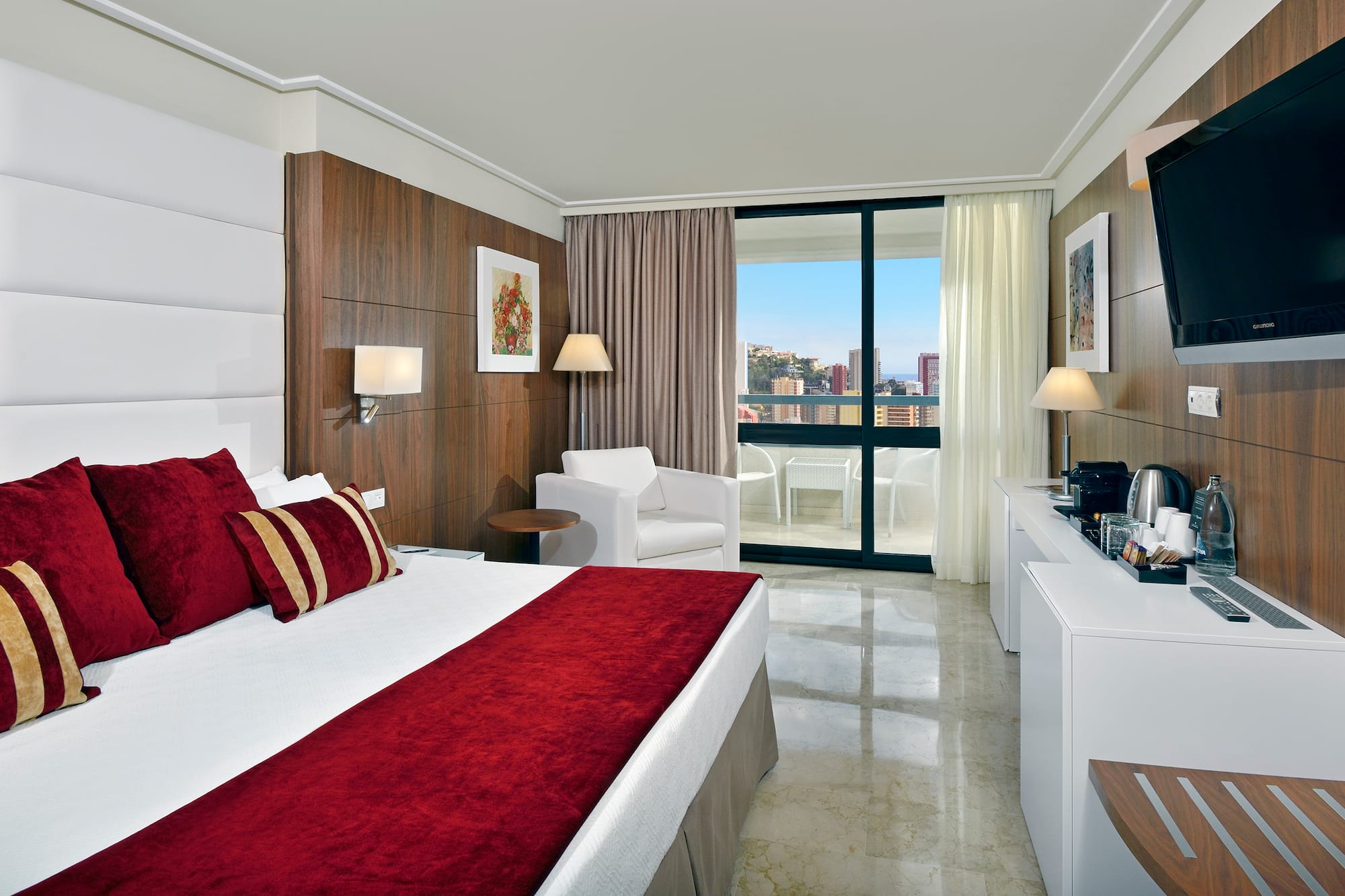 a bedroom with a bed and a white chair