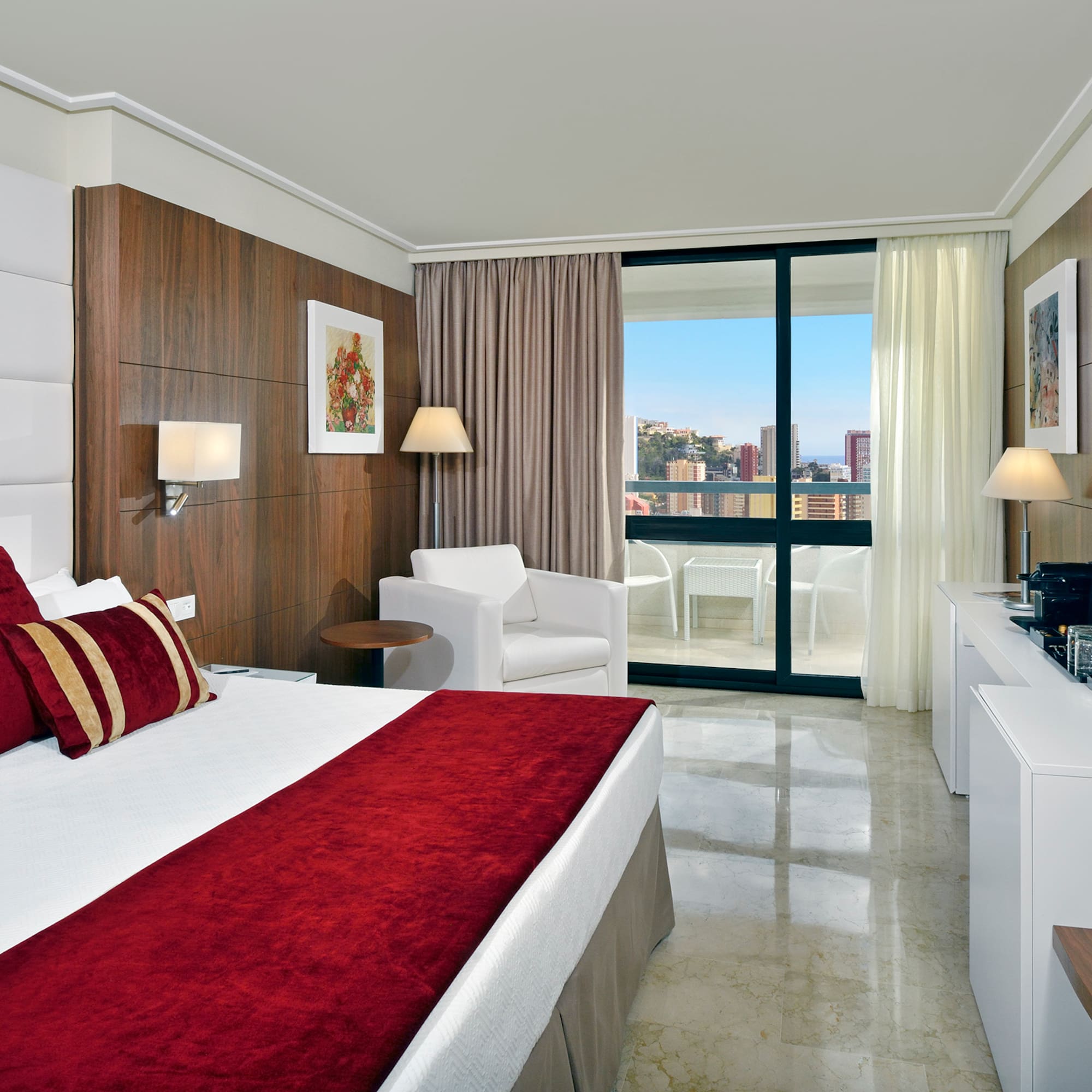 a bedroom with a bed and a white chair