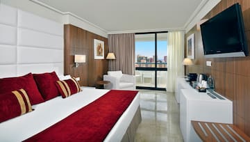 a bedroom with a bed and a white chair