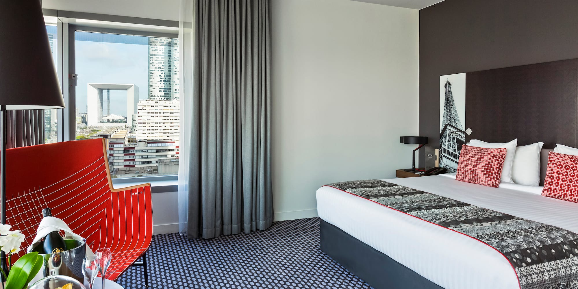 a room with a bed and a red chair