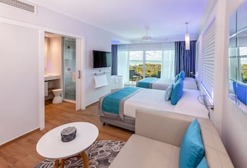 a room with two beds and a television