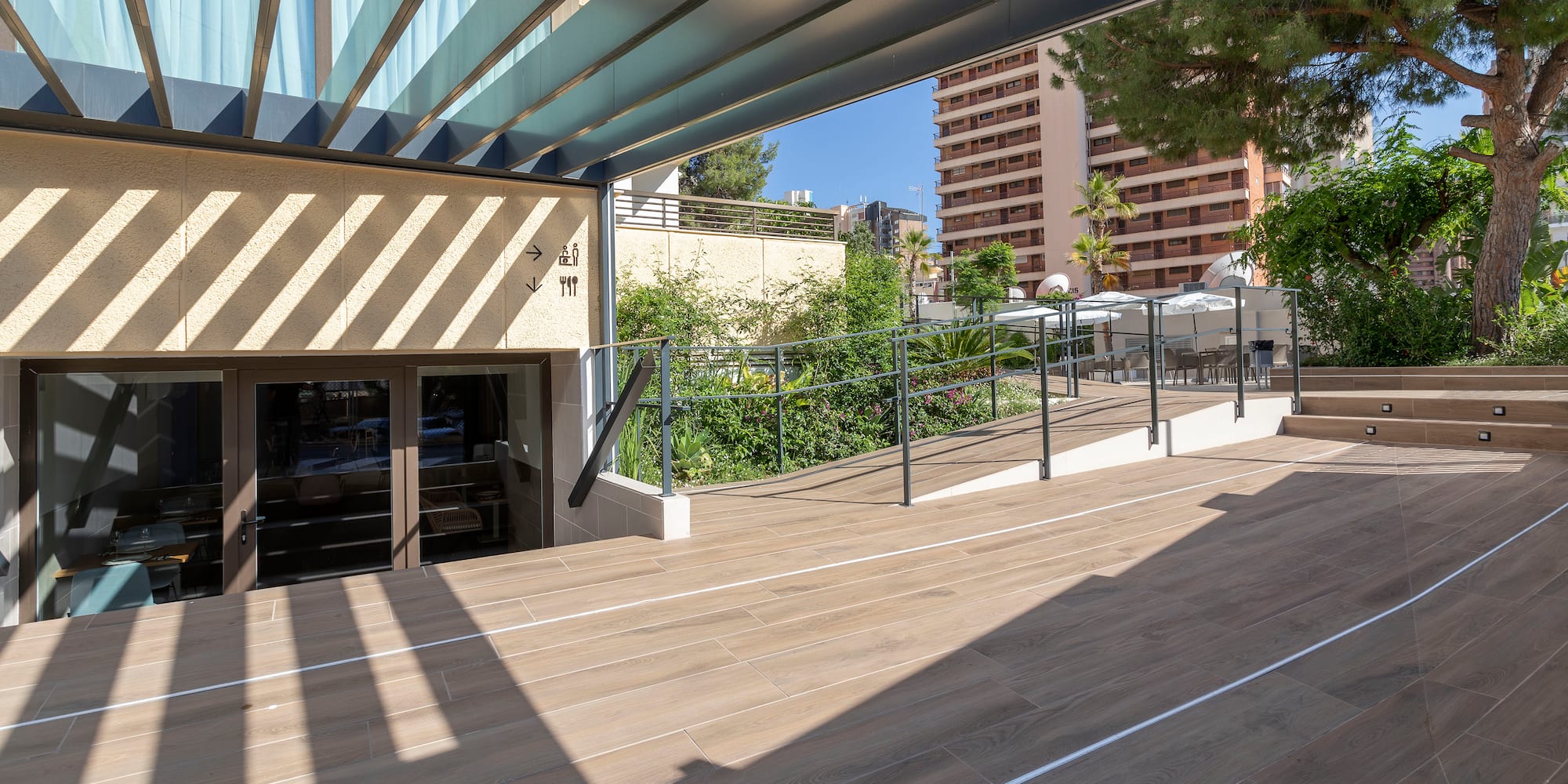 a wooden deck with a railing and trees in the background