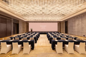 a large room with a large screen and tables